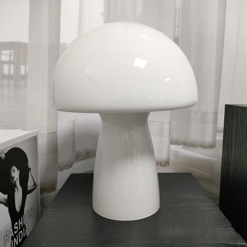 White Molanizzi mushroom-style glass table lamp on a dark surface