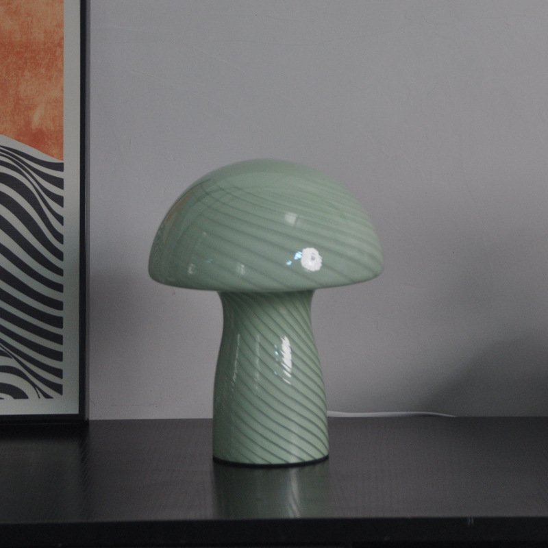 Molanizzi green glass mushroom lamp on a black table