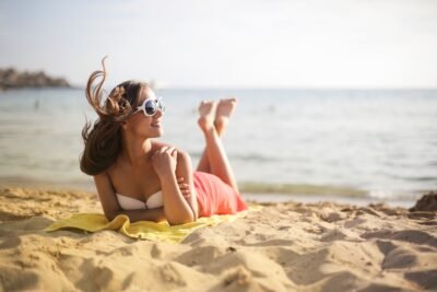 Woman in sunglasses for Molanizzi High-Fashion Sun Care & Beach Glam Style
